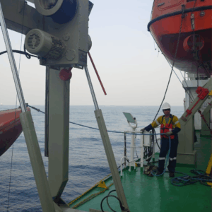 OJ Safety technician performing lifeboat and davit inspection on board vessel in Klaipėda, Lithuania under IMO MSC.402(96) and RINA approval – Baltic Sea fleet safety service