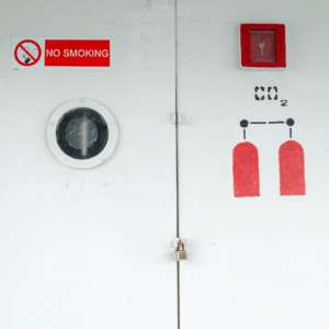 CO₂ firefighting system cabinet on ship – part of SOLAS Chapter II-2 and IMO MSC.1/Circ.1318 safety compliance inspected by OJ Safety across Baltic and European ports.