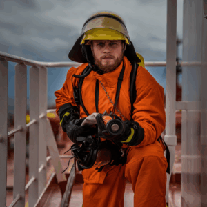 Marine firefighter in full protective suit during onboard fire drill under SOLAS Chapter II-2 and IMO MSC.1/Circ.1432, performed by OJ Safety engineers in European waters.